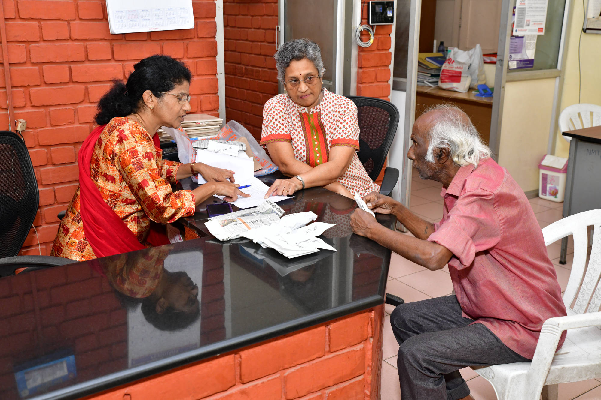 SK staff interacting with an elder